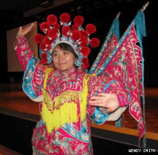 One of the visiting performers demonstrates costume and style.